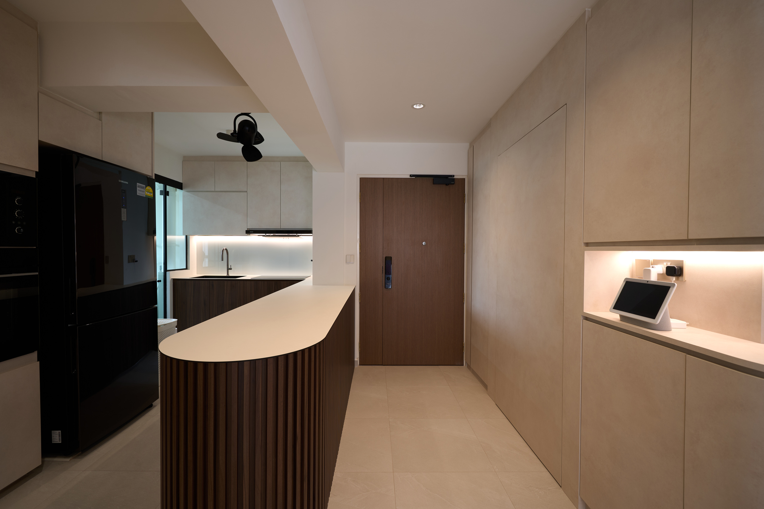 entryway with concealed shoe cabinet and kitchen island on the other side